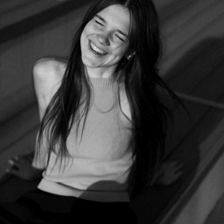 Avery Quinn, Lead Design Curator at Quay Cove Petal, reviewing corporate floral arrangements